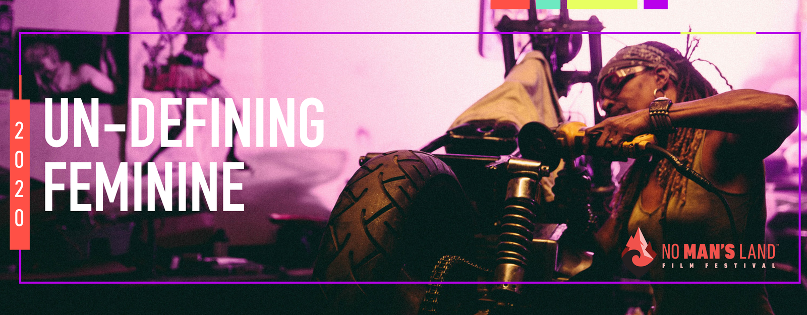 2020 Un-Defining Feminine: No Man's Land Film Festival. Black woman with goggles on and power tools working on a motorcycle.