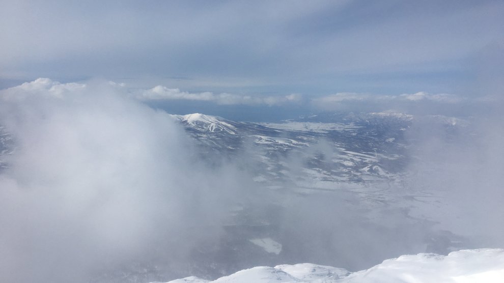 View from the crater rim: the ocean in the back, and snow-covered hillside in the middle.