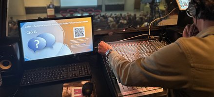 AV booth with audio operator at back of auditorium