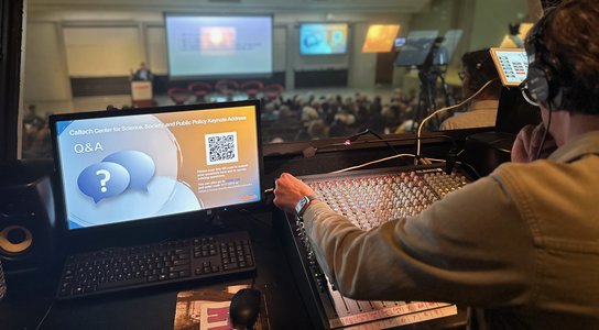 AV booth with audio operator at back of auditorium