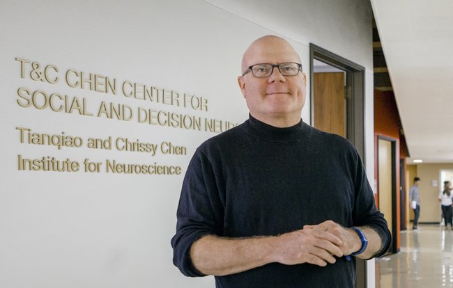 camerer in front of sdn wall sign - crop