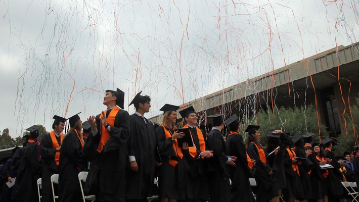 students at Commencement with confetti