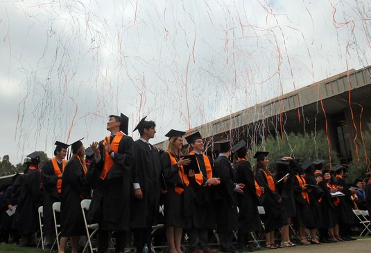 students at Commencement with confetti