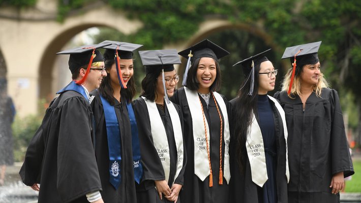 students in Commencement cap and gown