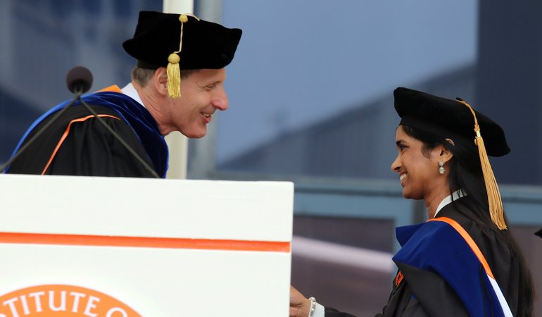 President Thomas Rosenbaum presenting a student award