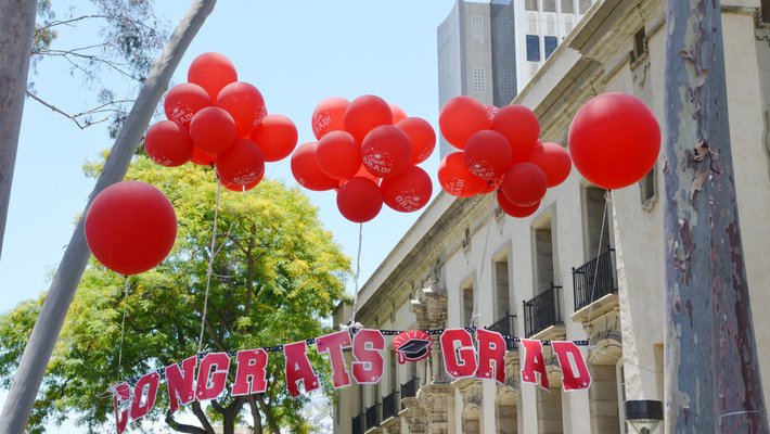 balloons and congratulations banner near Parsons-Gates Hall of Administration