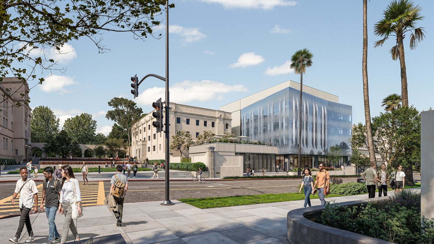 glass building with palm trees. Sky is light blue and people are walking on the sidewalk.