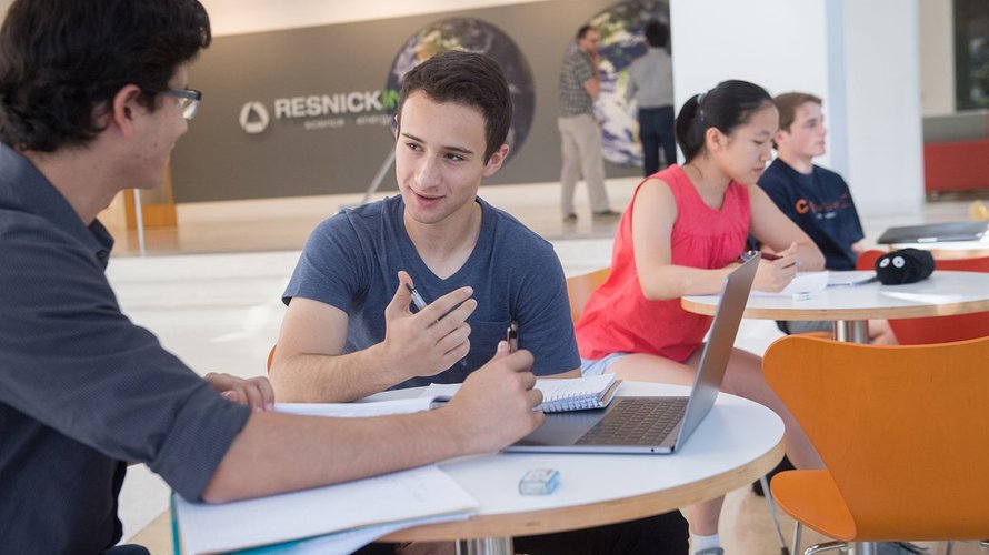 Two students, sitting at a table.