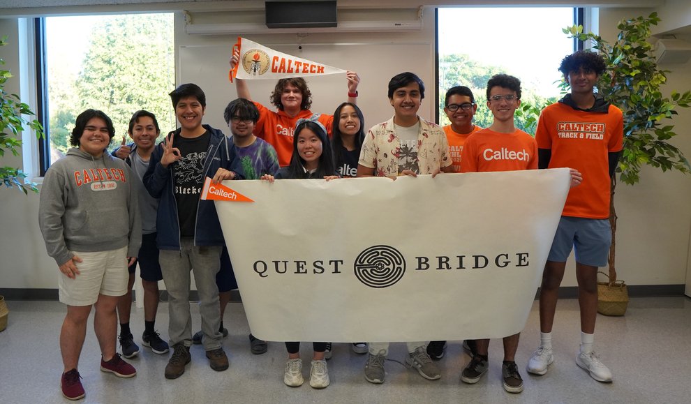 group of people holding signing and smiling at the camera