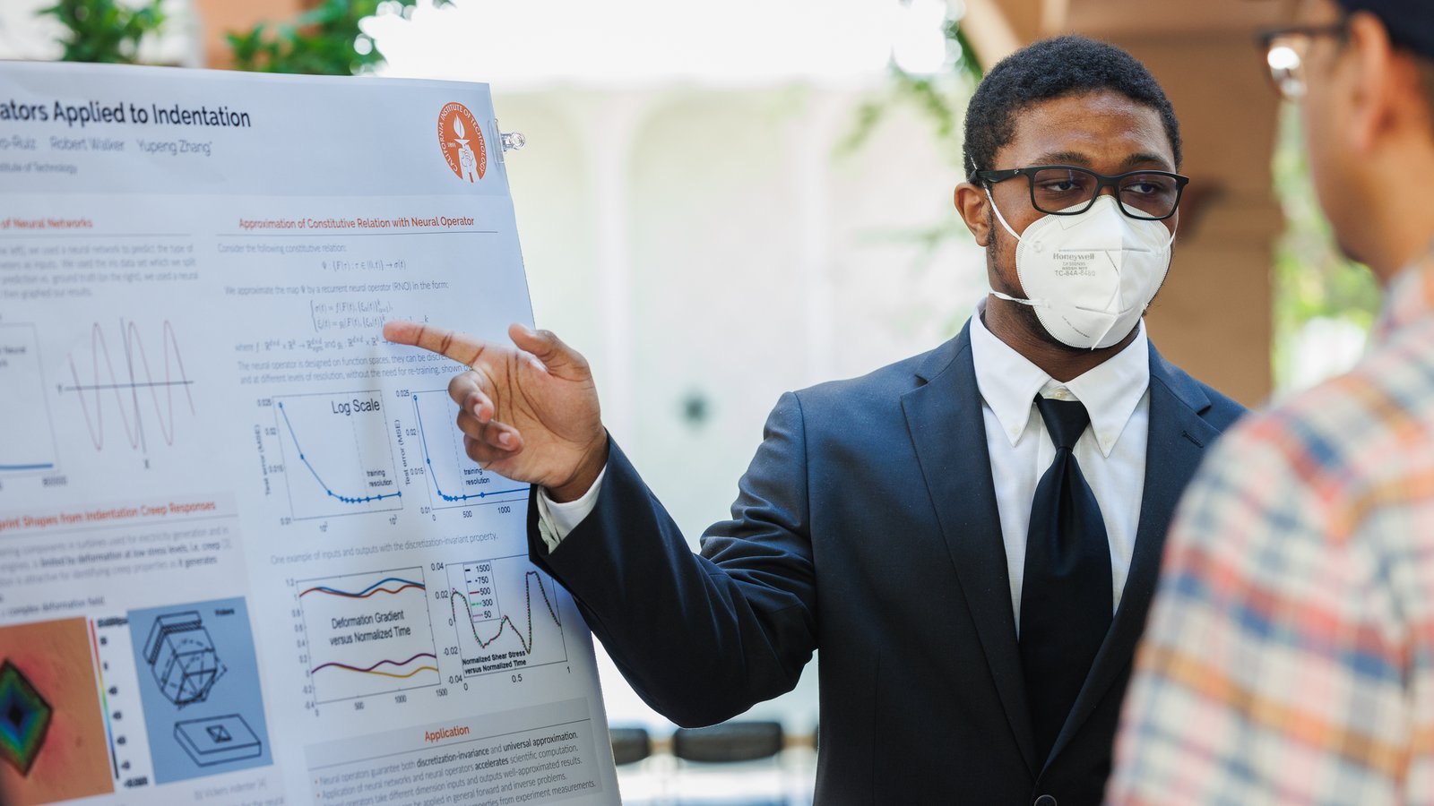 An FSRI student explains their research poster to an audience member