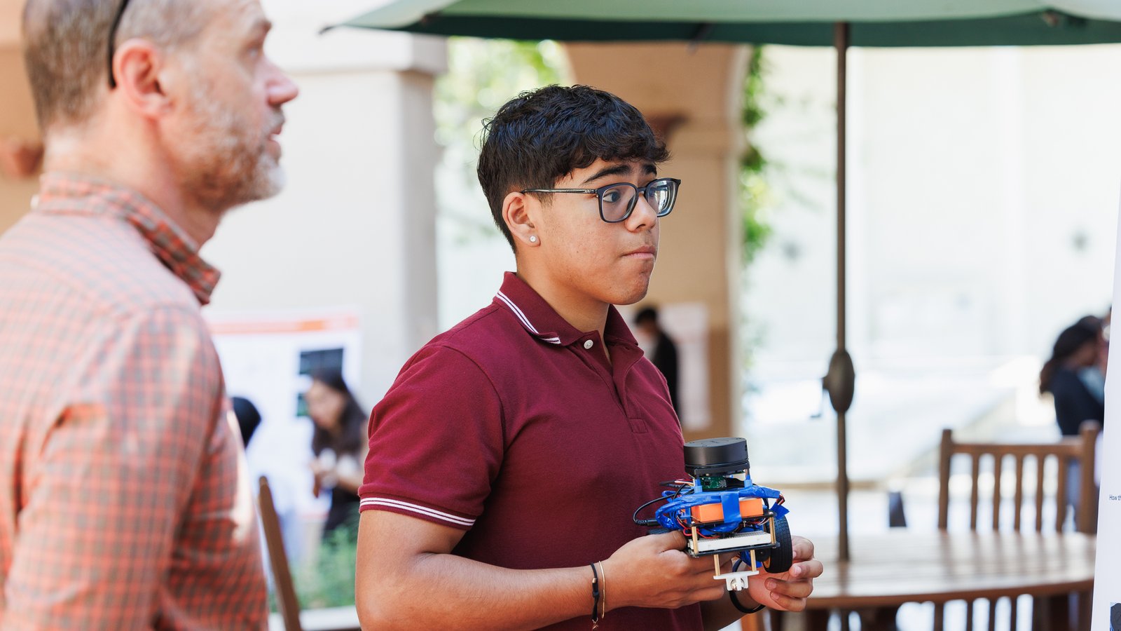 An FSRI student holding a robot they created