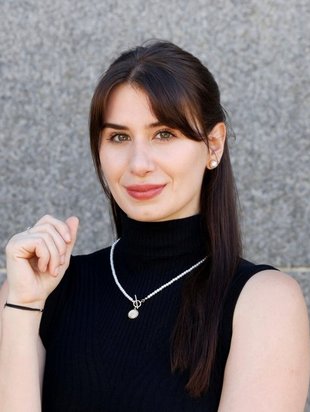person who identifies as a women smiling. person has on a black shirt