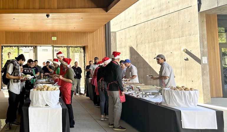 Banquet tables with managers serving and employees receiving