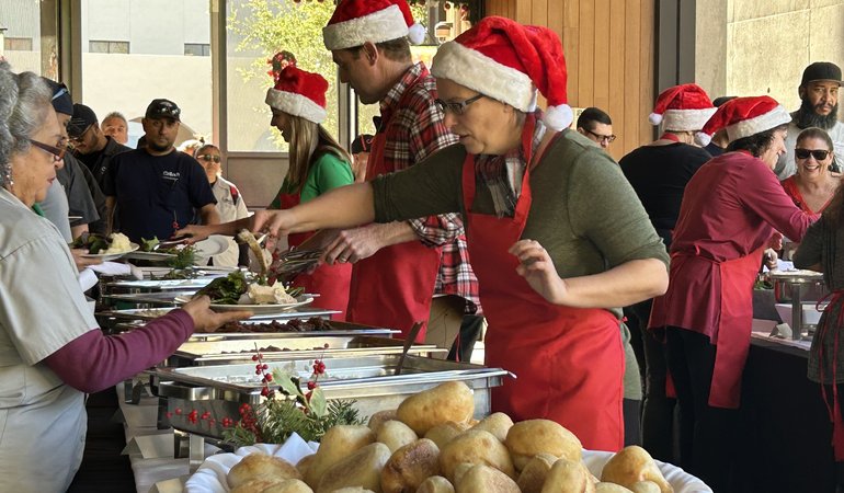 Banquet with servers in santa hats and red aprons