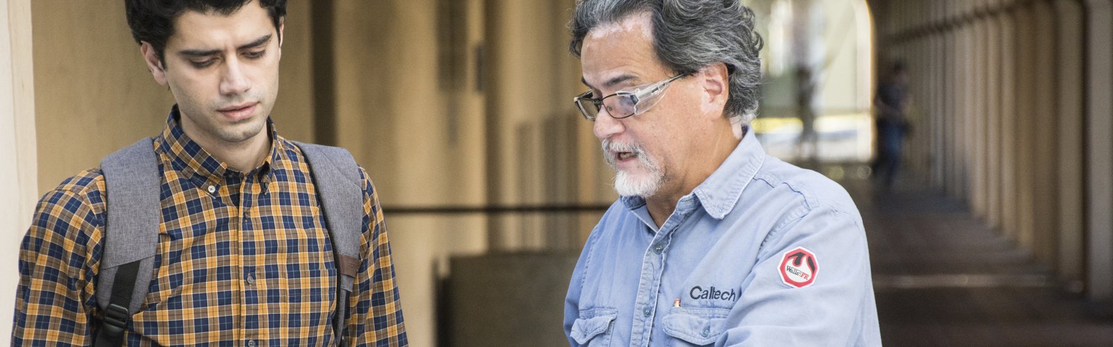 An electrician helps a student