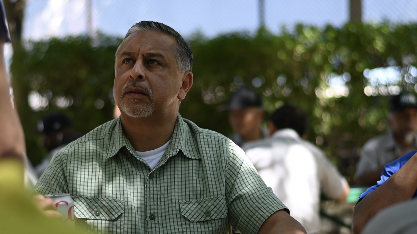 Man in green shirt at summer bbq