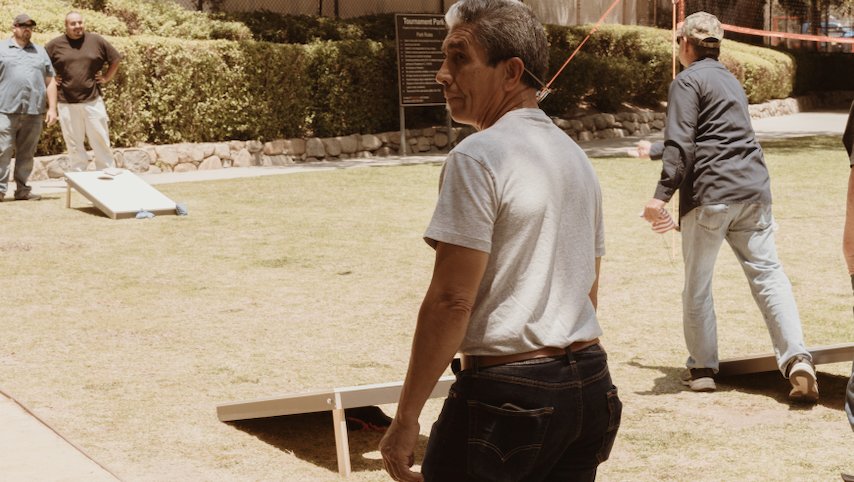 Raul Hernandez of the Carpenter Shop playing Corn Hole, 2023 Summer BBQ