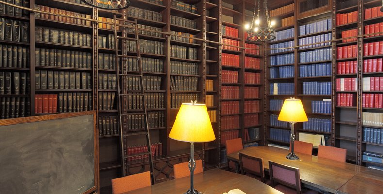 An image of an old fashioned library with shelves filled with books