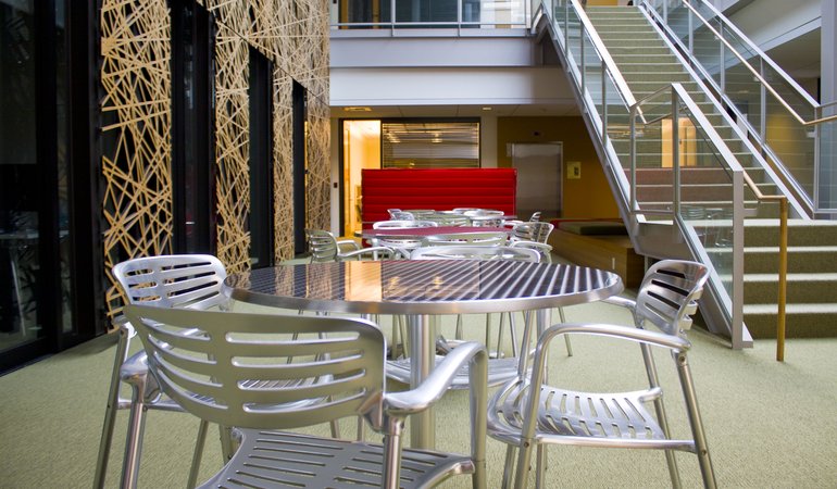 shiny metal chairs and table sit in a modern lounge area