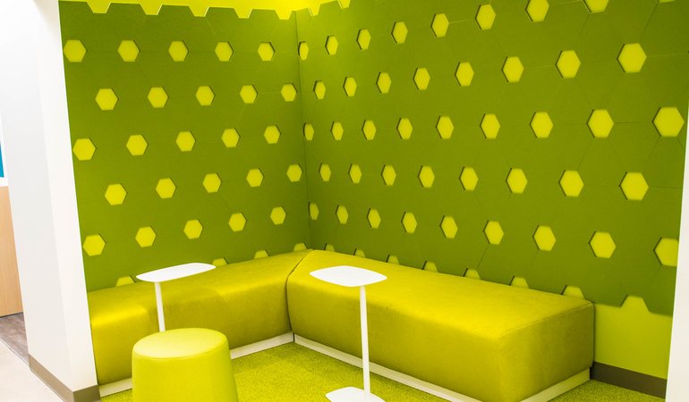 A modern lounge area with stuffed vinyl walls