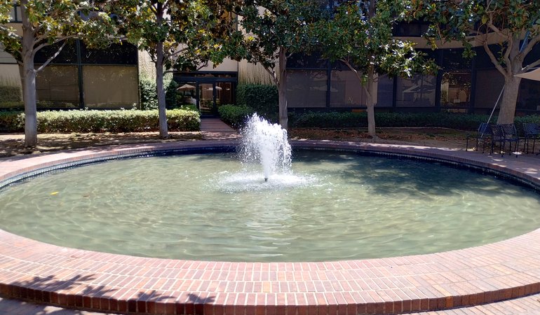 A large circular fountain lined with bricks