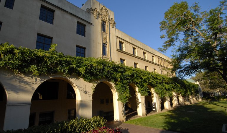 The exterior of a building with archways and plants