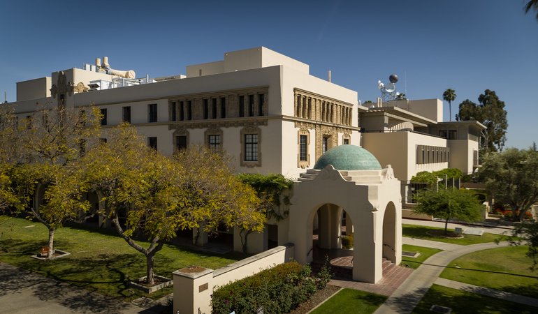 A building with archways and a blue tile dome