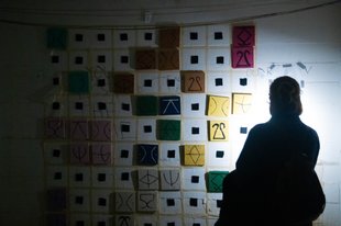 Person stands in front of board