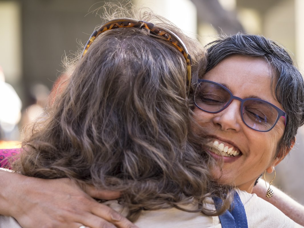 An image of a parent and their child hugging at a Caltech event