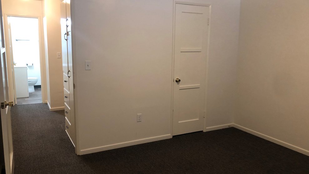 Bedroom and hall for 180-88 Catalina apartments with view of bathroom.