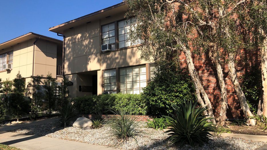 Exterior of 180-88 Catalina apartments with view of landscape.