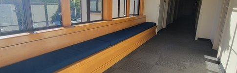 view of Avery hallway with a bench stretching the entire length below the windows