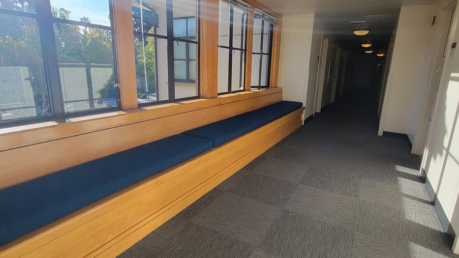 view of Avery hallway with a bench stretching the entire length below the windows