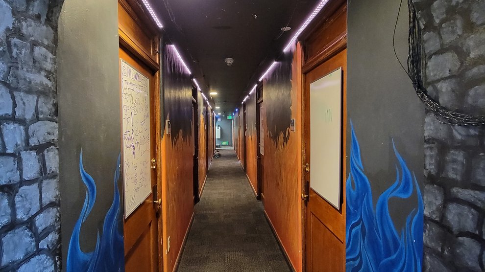 interior view of Blacker House Hallway with murals of fire and brick extending the entire length