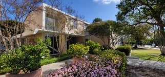 view of Marks House main entrance beside blooming, purple lantana flowers