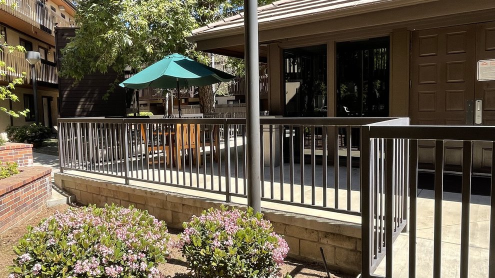 Catalina Outdoor Space featuring tables and foliage.