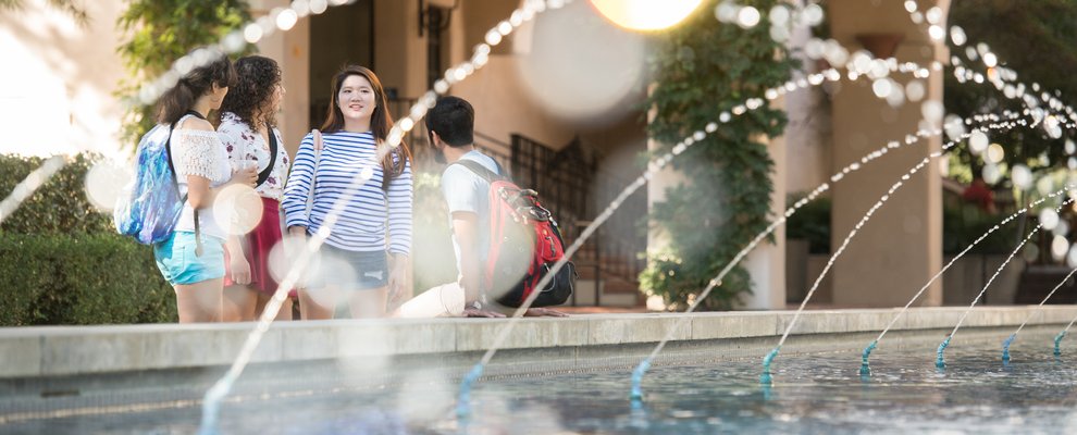 Students gathering near the Gene Pool featuring the gene pool fountain.