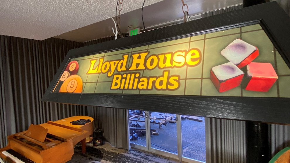 illuminated billard-themed light fixture for Lloyd House hanging above a pool table