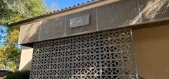 The entrance to Page house showing the Page House sign above a wall made out of concrete lattice work