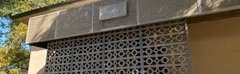 The entrance to Page house showing the Page House sign above a wall made out of concrete lattice work