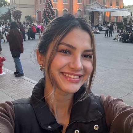 A woman smiles at the camera