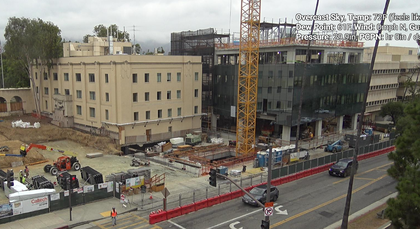 Progress of the Ginsburg Center construction, focusing on the installation of the glass curtain wall.