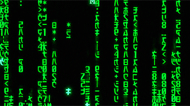 Green alphanumerics scrolling on screen spell out The Matrix