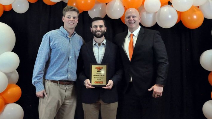 Trio of men at award ceremony