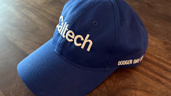 A Dodger-blue Caltech baseball cap