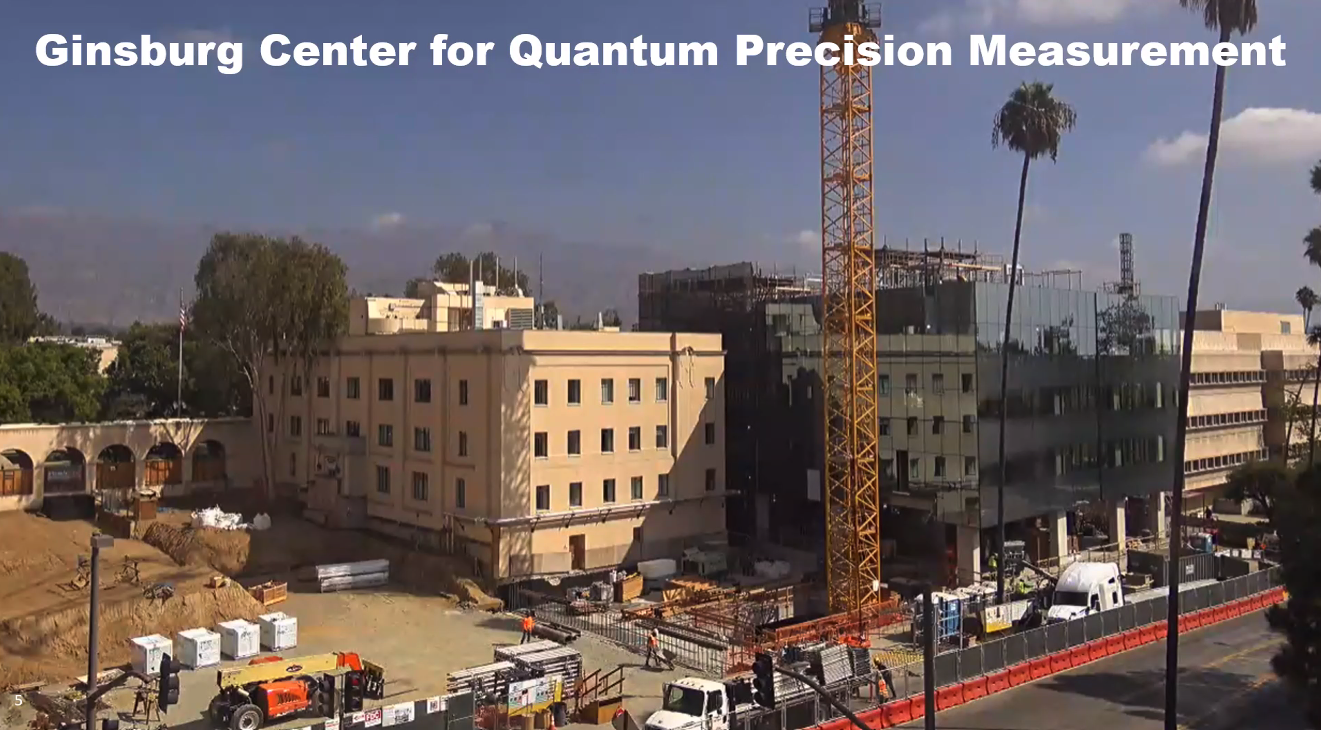 A photo of two buildings, one of which is in construction progress. A construction crane is in the foreground.