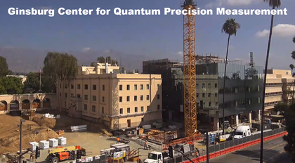 A photo of two buildings, one of which is in construction progress. A construction crane is in the foreground.