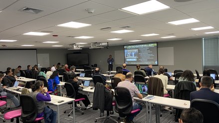 Aguilar presenting in front of a group of workshop participants in Lima, Peru