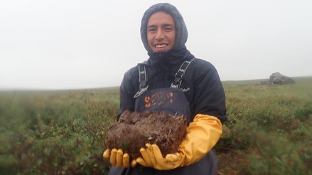 Isaac holding a sample of active layer soil