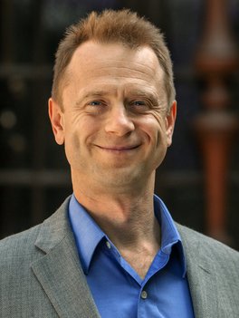 Rustem Ismagilov  wearing an blue shirt and gray sports jacket